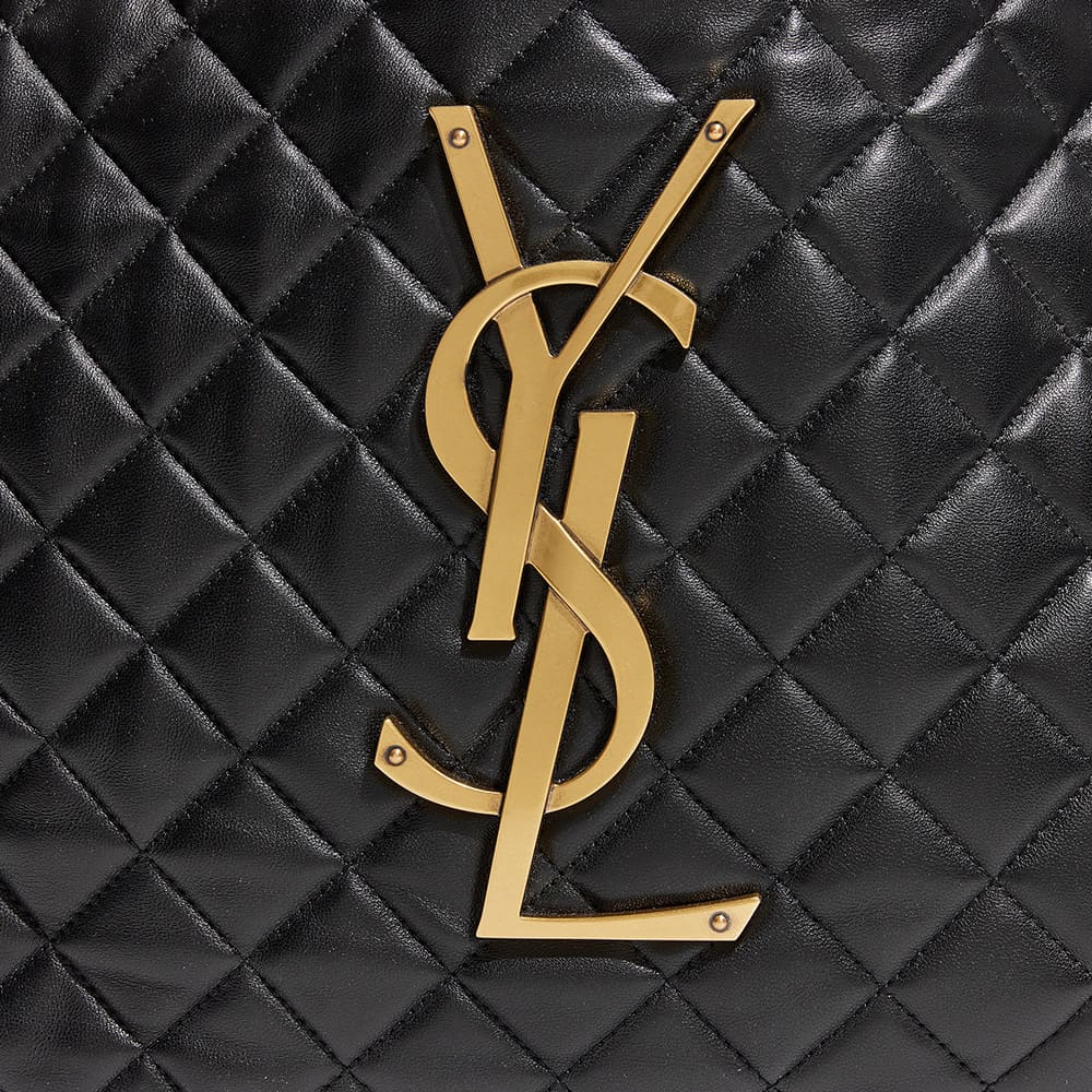 the side view image of a fake saint laurent icare maxi shopping tote showing the gold YSL logo hardware by FASHIONPHILE