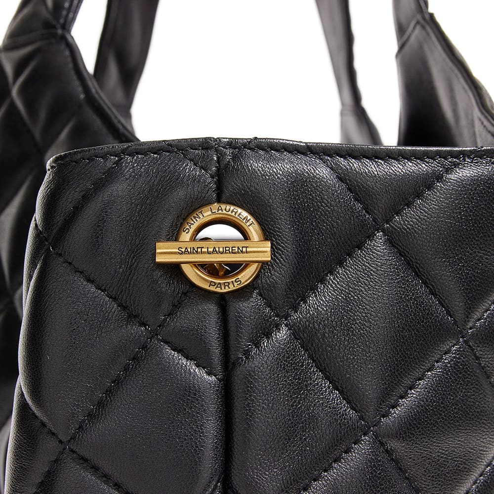 he side view image of a fake saint laurent icare maxi shopping tote showing the branded gold hardware by FASHIONPHILE