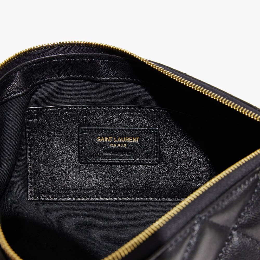 the interior of a fake saint laurent icare maxi shopping tote showing the brand tag by FASHIONPHILE