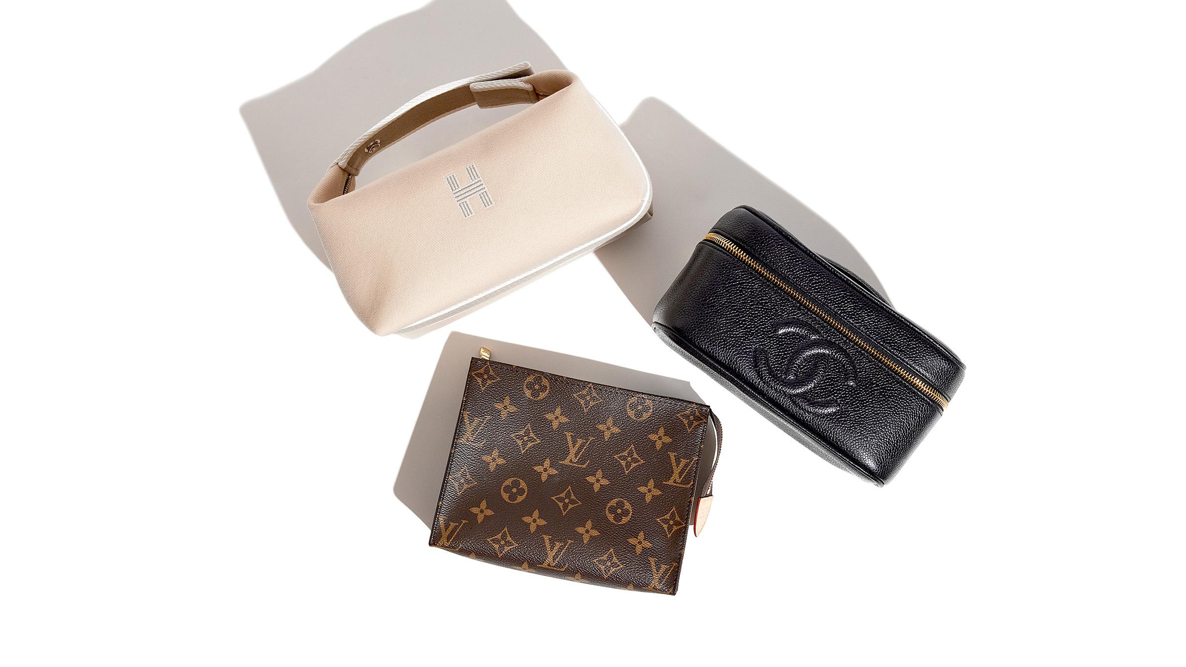 Luxury toiletry bags from Hermes, Chanel, and Louis Vuitton grouped together by FASHIONPHILE