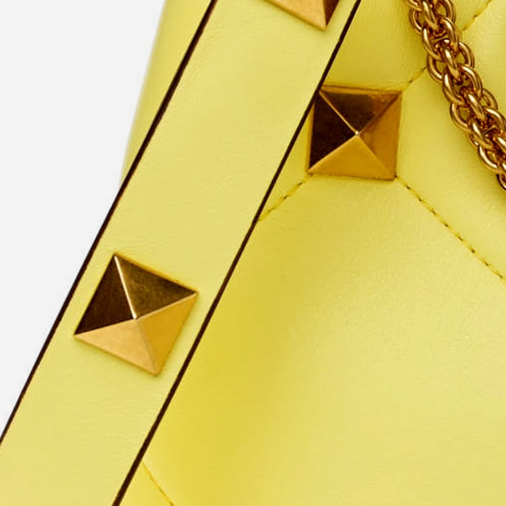 image of authentic valentino garavani roman stud hardware by FASHIONPHILE
