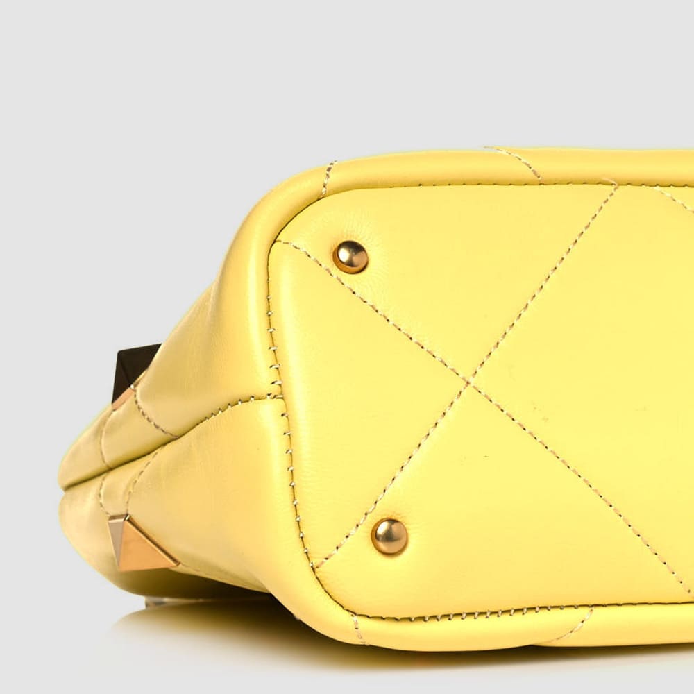 image of the bottom of a fake valentino garavani bag showing the stitching and placement of the hardware by FASHIONPHILE