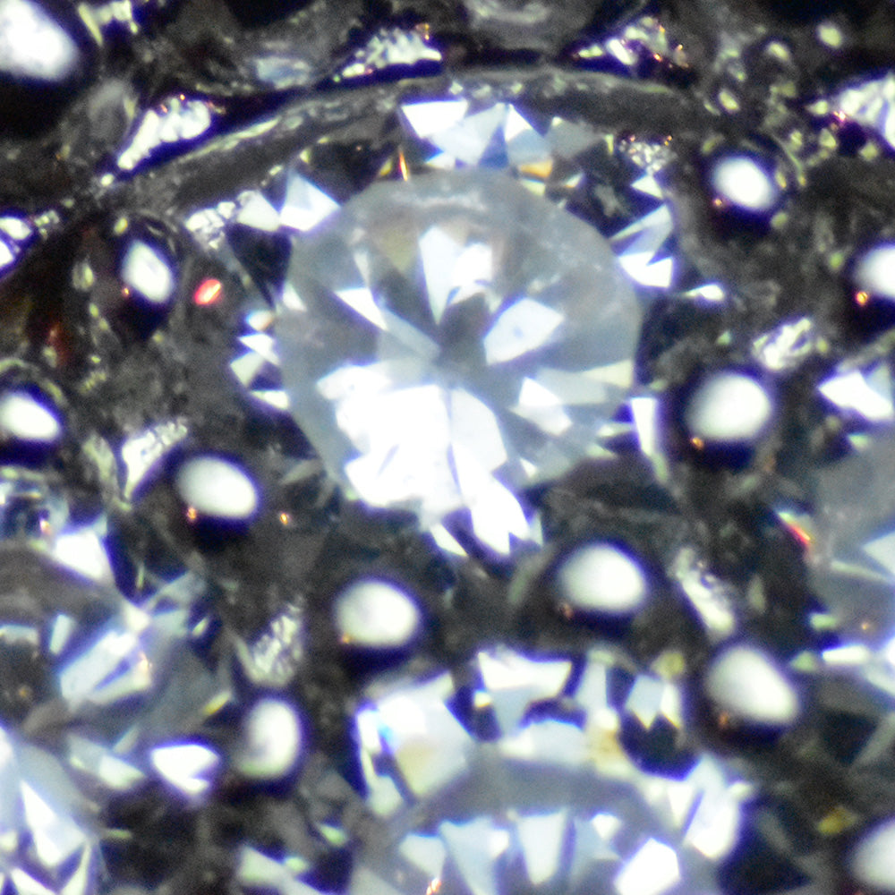 close up image of fake van cleef & arpels stones showing the illusion of diamonds but really made of cubic zirconia by FASHIONPHILE