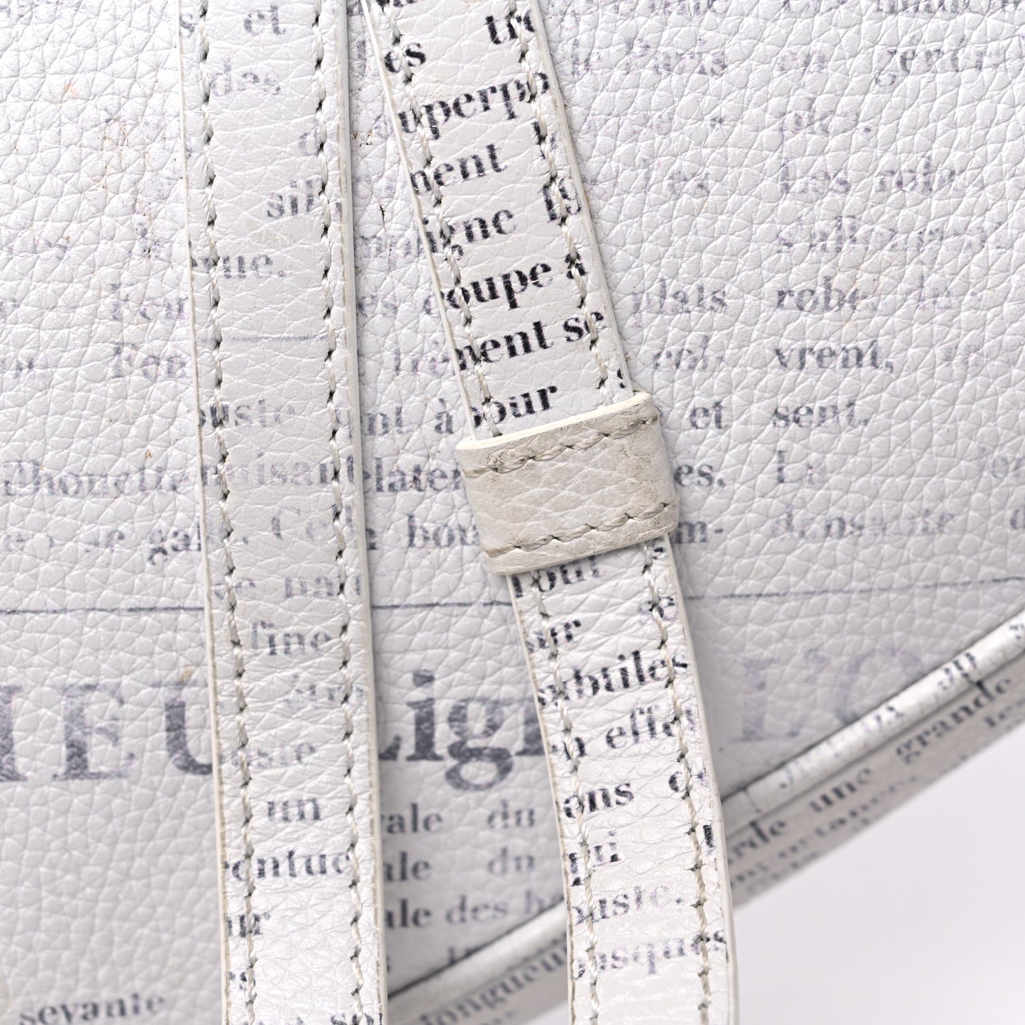 X DANIEL ARSHAM Grained Calfskin Newspaper Print Saddle Bag White
