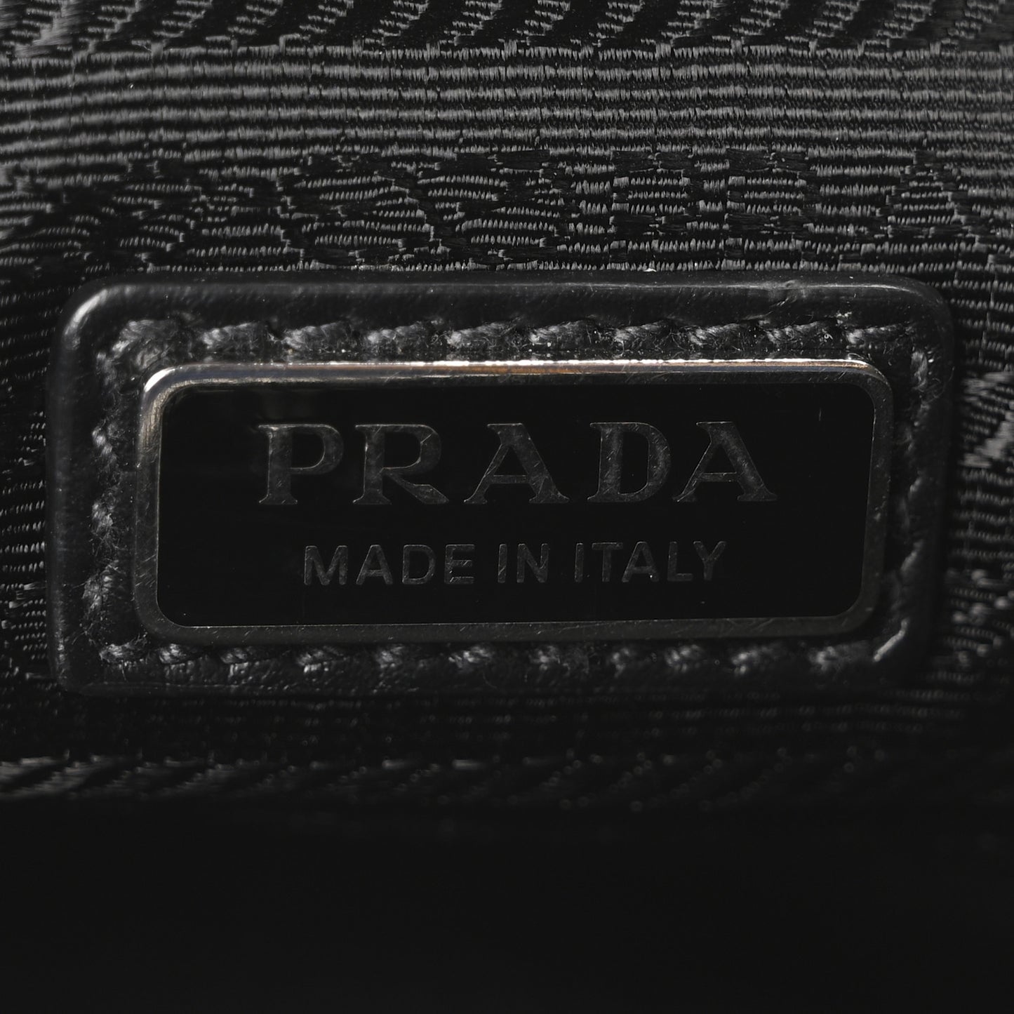 Saffiano Cuir Triangle Logo Embossed Triangle Wristlet Black
