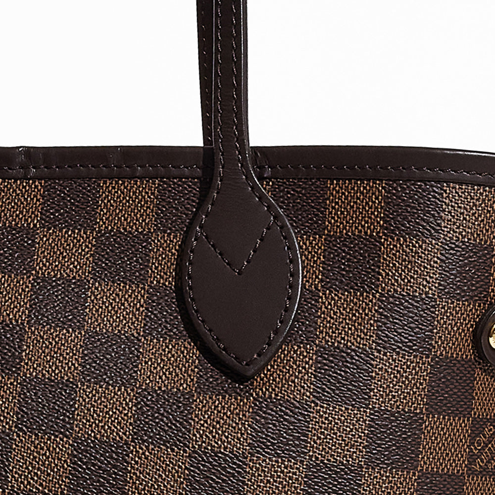 this is a close up image of an authentic louis vuitton neverfull's leather and canvas by fashionphile