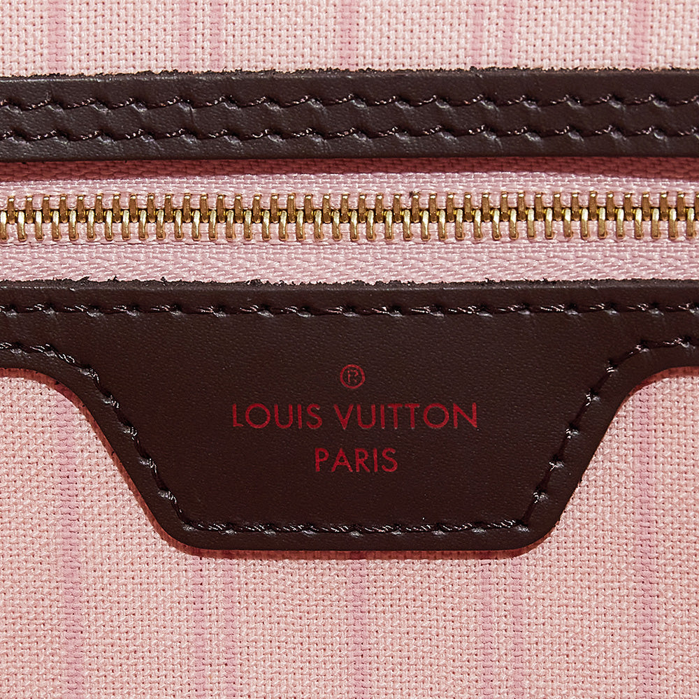 this is a close up image of an authentic interior logo stamp on a damier ebene louis vuitton neverfull bag by fashionphile