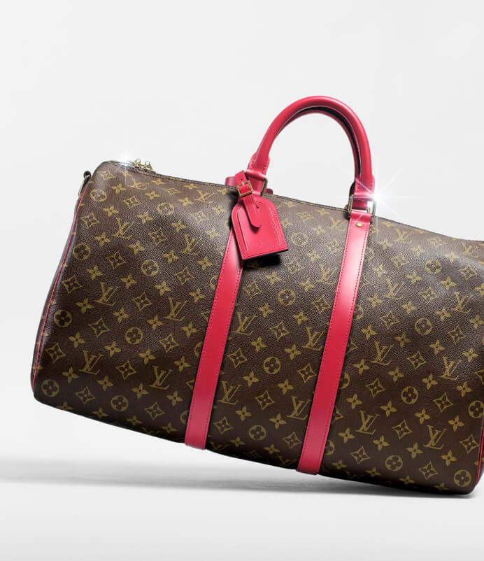 Louis Vuitton Keepall Monogram duffle bag with red leather handles