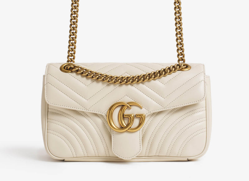 Gucci leather handbag with metal strap.