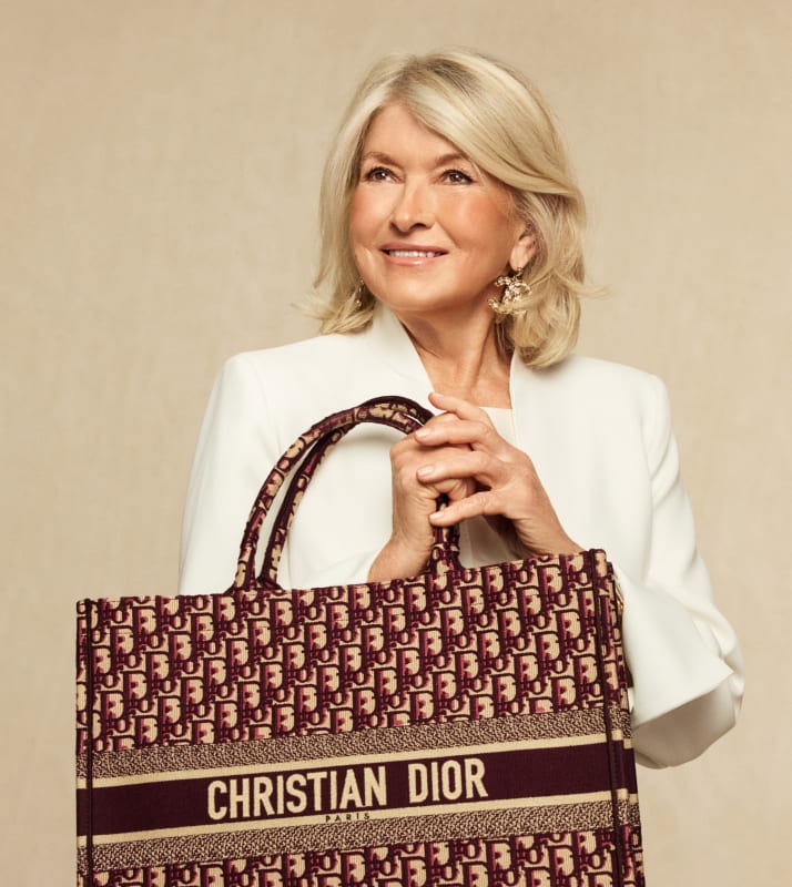 Martha Stewart in a white suit holding a CHRISTIAN DIOR Oblique Large Book Tote Burgundy