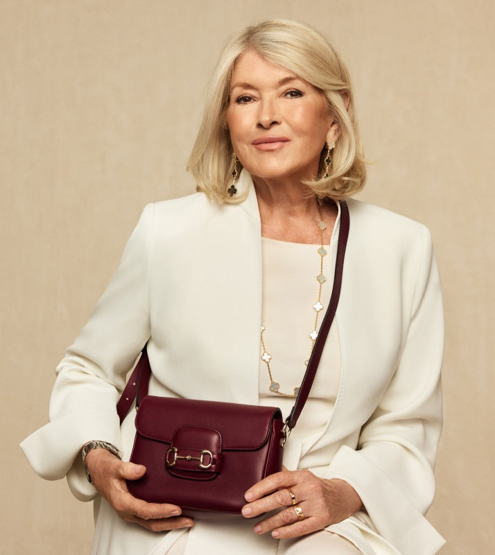 Martha Stewart in a white suit holding a red GUCCI Azalea Calfskin Horsebit 1955 Shoulder Bag  