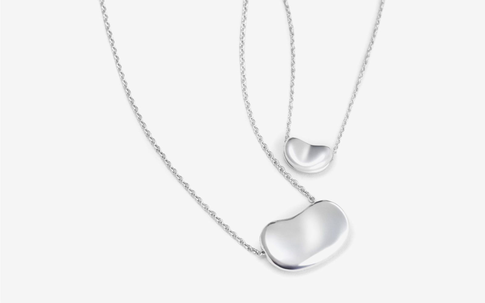 two Tiffany sterling silver Elsa Peretti bean pendant necklaces