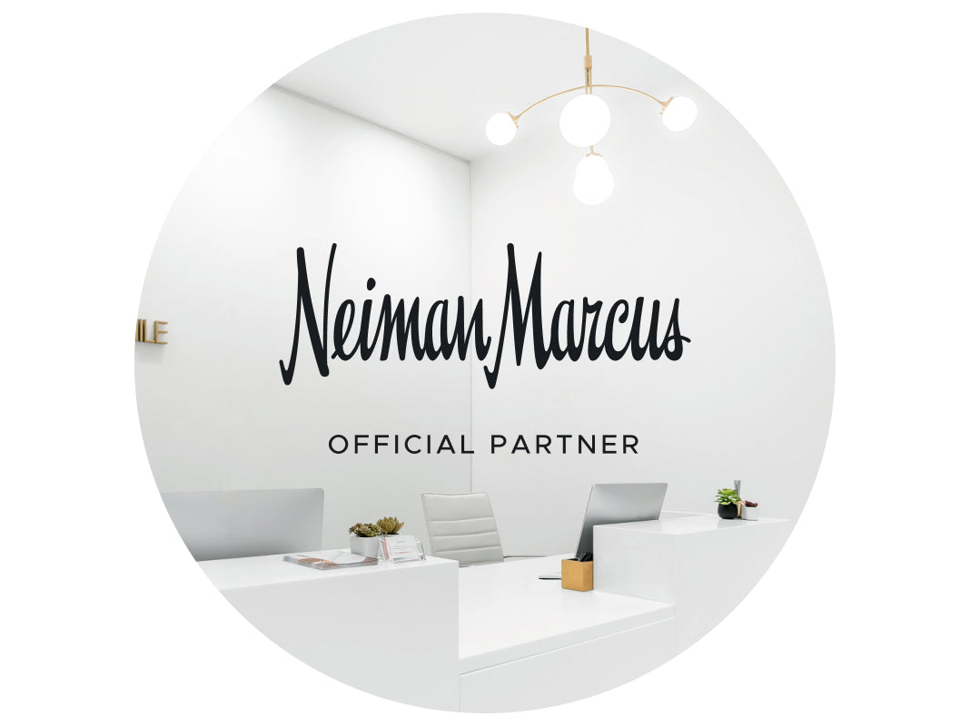 the interior of a Neiman Marcus studio with "Neiman Marcus Official Partner" in black text
