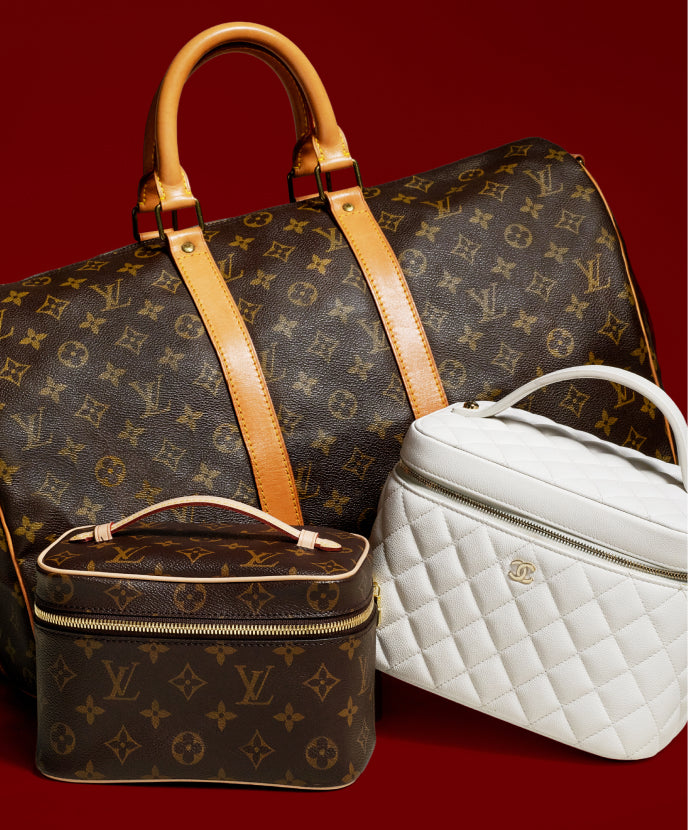 one Louis Vuitton Monogram Keepall sitting next to one Louis Vuitton Monogram Nice and one White Chanel Vanity case