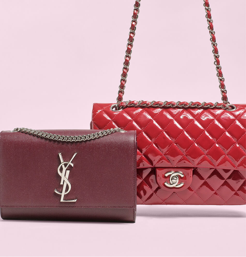 A red quilted Chanel shoulder bag with a silver CC turn-lock and chain strap, paired with a burgundy YSL wallet featuring a silver YSL logo, set against a solid pale pink background.