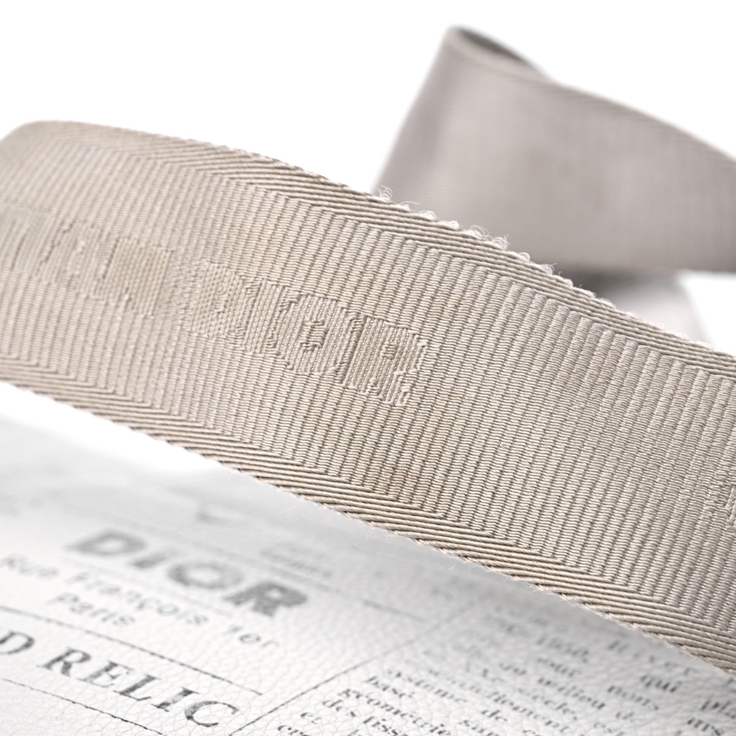 X DANIEL ARSHAM Grained Calfskin Newspaper Print Saddle Bag White