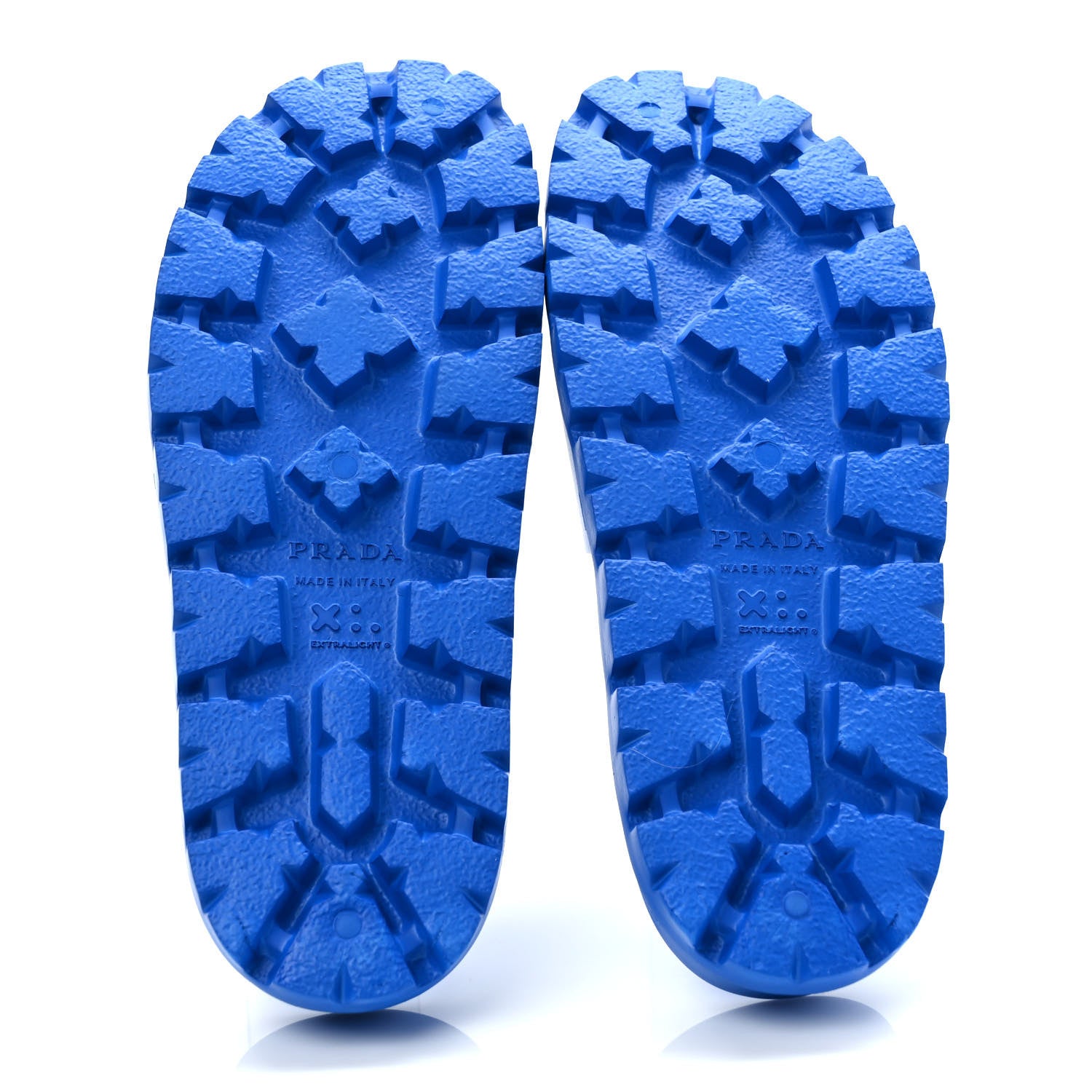 Bottom view of a pair of blue Prada rubber slide sandals revealing the sole by FASHIONPHILE