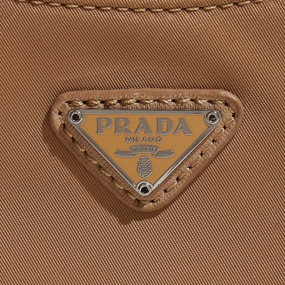this is an image by FASHIONPHILE of a fake Prada Mini Re-Edition bag 2000 in beige