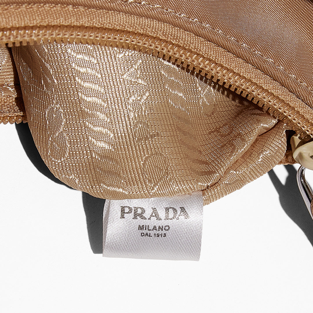 this is an image by FASHIONPHILE of a fake Prada Mini Re-Edition bag 2000 in beige